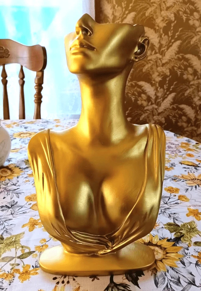 Gold-painted female torso sculpture with extended neck and draped fabric, made using a white silicone mold for Candle Making or resin casting
