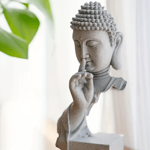 Making a peaceful Buddha sculpture with closed eyes and raised finger to lips using silicone mold