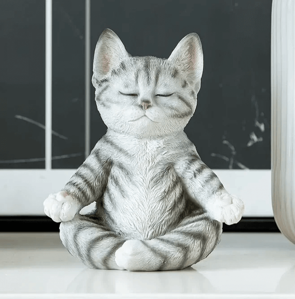 Cat sitting cross-legged in meditation pose with eyes closed, created using silicone mold for candle or soap making