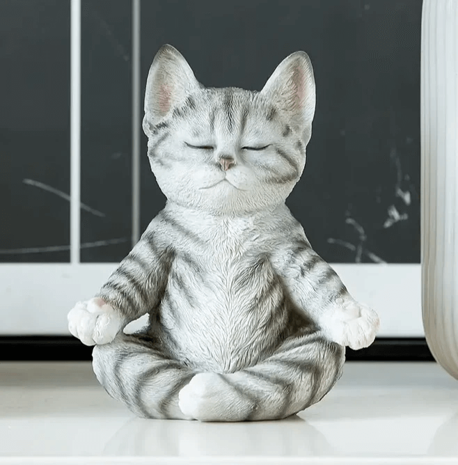 Cat sitting cross-legged in meditation pose with eyes closed, created using silicone mold for candle or soap making