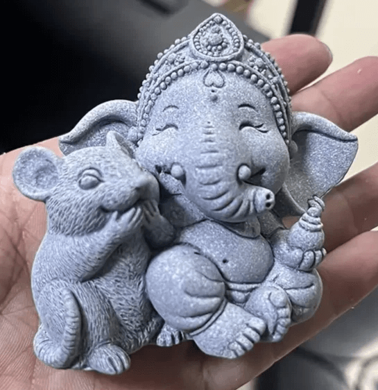 Small silicone Ganesha mold showing seated figure with crown and mouse companion in hand


