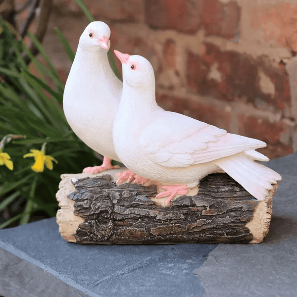Two white doves resting on rustic log, created using silicone mold, symbolizing love and harmony


