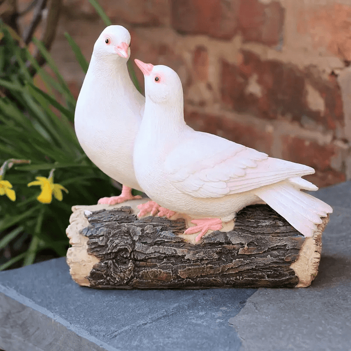 Two white doves resting on rustic log, created using silicone mold, symbolizing love and harmony


