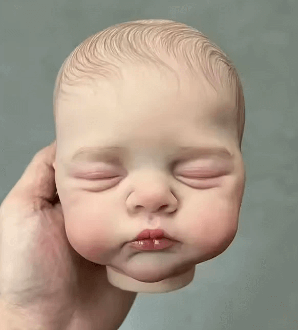 Making sleeping baby boy doll head with closed eyes and full cheeks using silicone mold for resin, soap, candle, or plaster casting