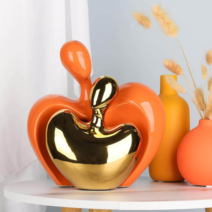 Abstract couple figure with heart-shaped orange and gold embrace, cast from white silicone mold for Candle Making
