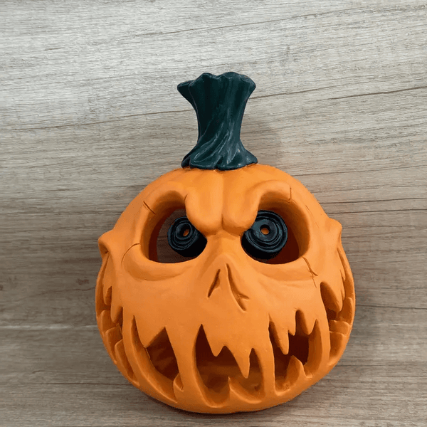 Large Halloween pumpkin with hollow eyes, open mouth, and twisted stem, created using white silicone mold for Candle or Resin Making