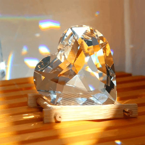 Crystal-style 3D heart with reflective facets sitting on a wooden base, made using silicone mold for resin, soap, candle, or plaster making