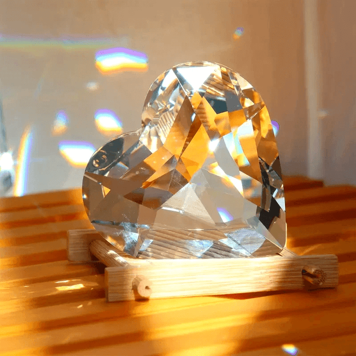 Crystal-style 3D heart with reflective facets sitting on a wooden base, made using silicone mold for resin, soap, candle, or plaster making