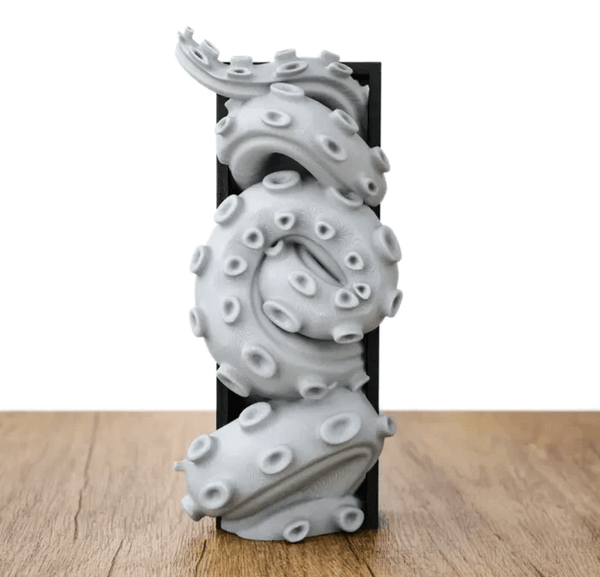 Curled octopus tentacle sculpture with suction details, made using silicone mold for candle making, resin casting, and soap or plaster art
