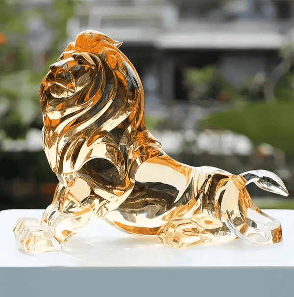 Golden resin casting of reclining lion with detailed mane and proud pose, created using silicone mold for resin making