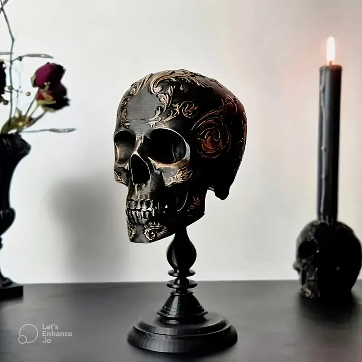 Black resin skull with gold baroque carvings, created using a silicone mold for resin casting, hard plaster art, and beeswax candle making.