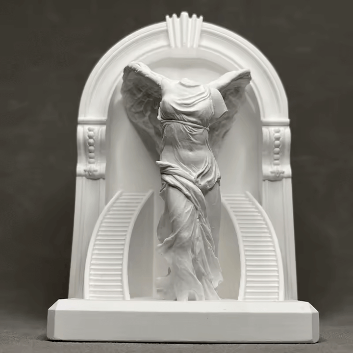 Winged goddess figure draped in flowing robes under classical arch, created with silicone mold


