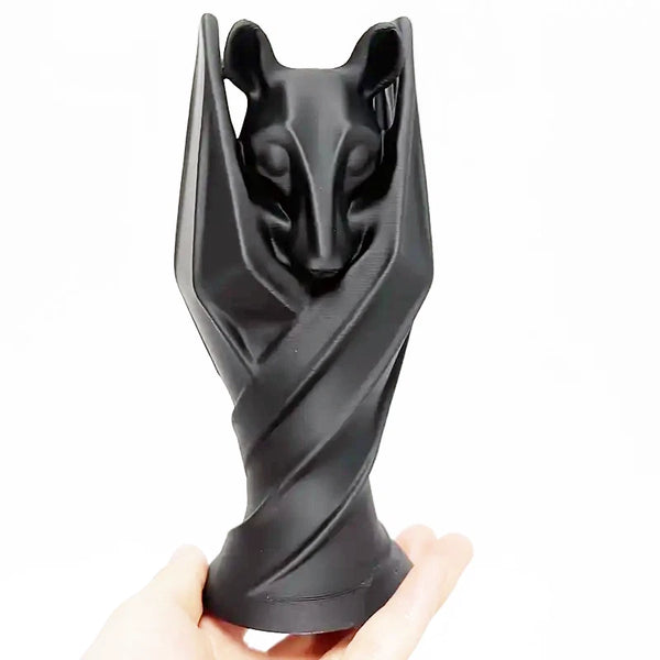 Gothic bat sculpture with wings wrapped around body in upright pose, created using silicone mold


