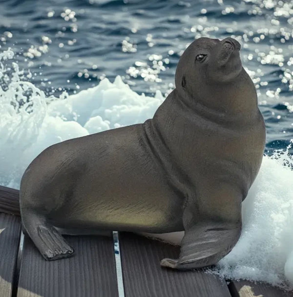 Realistic sea lion sculpture seated with upright posture on deck, created using silicone mold for ocean-inspired decor


