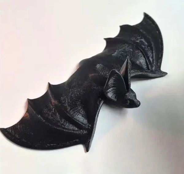 Flying bat sculpture with extended wings and gothic styling, created using silicone mold for wall-mounted decor



