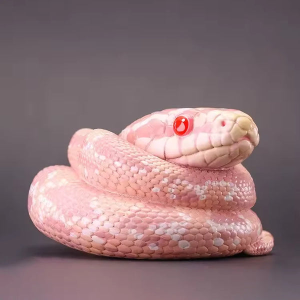 Coiled snake sculpture with realistic scales and lifelike head, created using silicone mold for gothic or fantasy art


