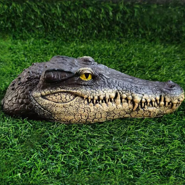 Realistic crocodile figure lying on grass, showing textured scales and snout, created using silicone mold


